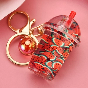 Macro detail of acrylic milk tea keychain with red liquid and miniature watermelon slices