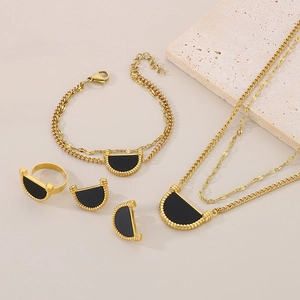 Elegant gold titanium steel jewelry set featuring black enamel semi-circle inlays