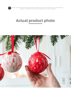 Detail of red and white Christmas balls with forest tree patterns and red ribbon hangers