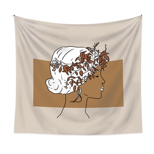 Close-up of minimalist line art wall tapestry featuring female profile and brown leaves