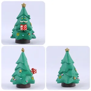 Creative Christmas tree figurine with resin Santa features holding a striped gift box