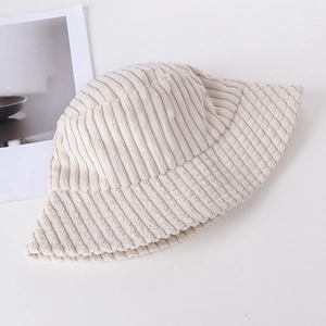 Detail of cream corduroy bucket hat texture and minimalist warm autumn design