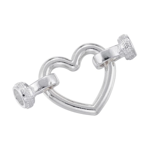 Close-up of heart-shaped nail design jewelry clasp in polished silver finish