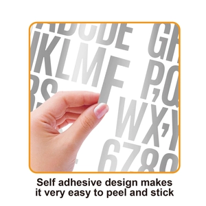 Macro view of peeling a self-adhesive rainbow gold letter sticker from its backing