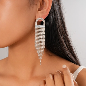 Detail of silver jellyfish tassel earrings with sparkling rhinestones worn by a model