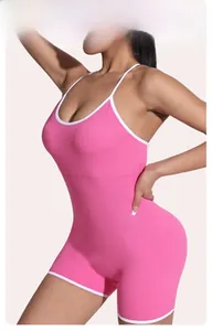 Close-up of pink ribbed yoga bodysuit featuring white contrast trim and thin straps