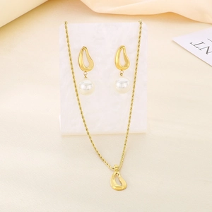 Detailed view of vintage gold titanium steel jewelry set with pearls and evil eye design