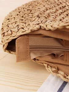 Handwoven round straw shoulder bag with zipper closure and durable khaki paper rope texture