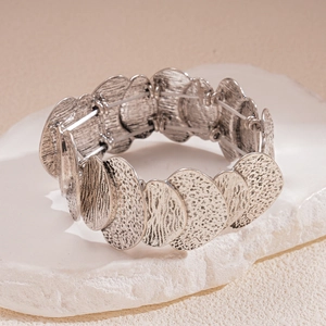 Vintage silver irregular geometric wide metal bracelet on a minimalist white stone base