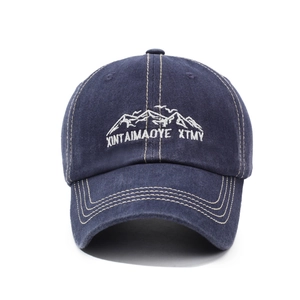 Retro washed navy baseball cap with white mountain embroidery and curved brim
