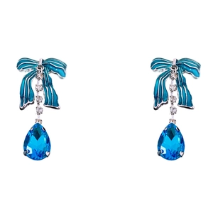 Blue enamel bow earrings with teardrop gem and sparkling crystal accents on white background
