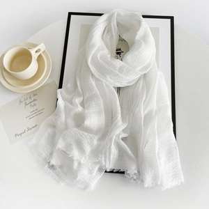 Detail of white cotton linen scarf texture with elegant coffee cup and minimalist frame