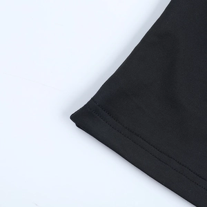 Close-up of the double-needle stitched hem and knit texture of a black long-sleeve T-shirt