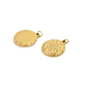 Macro detail of golden star embossed pendant with hammered texture and jump ring