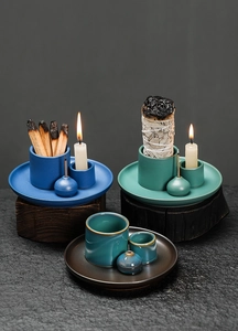 Detailed view of three ceramic incense burner sets with a kiln-glaze finish on wood