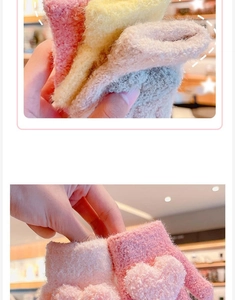 Detail of plush heart-shaped motifs on soft winter gloves in pink and beige colors