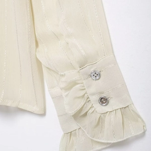 Beige striped blouse cuff detail with elegant ruffle trim and double-button closure