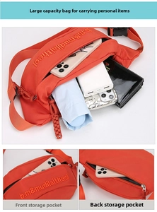 Detail view of large capacity orange waist bag showing front pocket and back zipper pocket