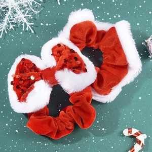 Red velvet Christmas scrunchies with plush white trim and a sparkly sequin bow detail