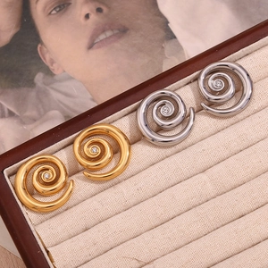 Detailed view of 18K gold and silver plated spiral earrings with a center zircon inlay