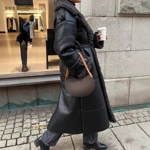 Chic black long faux shearling coat with belt and plush collar for winter street style