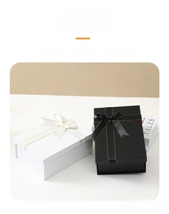 Black and white foldable gift boxes featuring elegant silk ribbon bows with gold edges