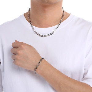 Polished silver titanium steel chain necklace and bracelet set on male model