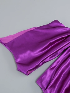 Detail of glossy purple satin fabric showing smooth texture and elegant drapes of the dress