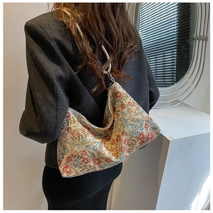 Detail of floral underarm hobo bag with unique rope handle and vintage ethnic patterns