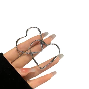 Silver twisted heart hoop earrings with metallic texture for women fashion