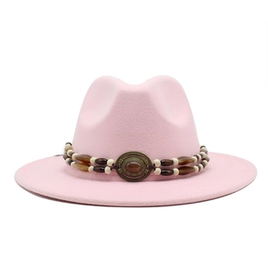 Detailed view of pink wool felt fedora with vintage beaded band and amber gemstone