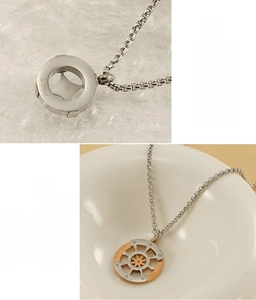 Detailed close-up of retro stainless steel star compass pendant with S.Steel engraving