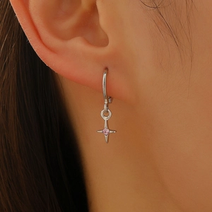 Silver hoop earrings with a star pendant featuring a pink center gemstone