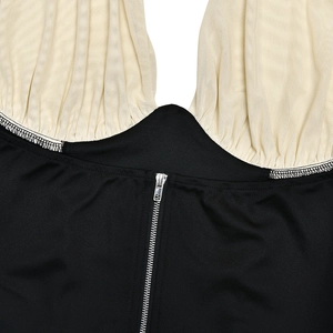 Detail view of contrast stitching halter top with beige mesh and silver zipper closure