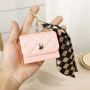 Pink quilted mini coin purse charm with gold clasp and decorative silk ribbon