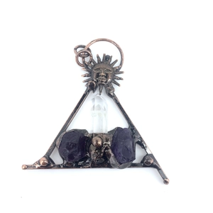 Irregular amethyst crystal pendant with bronze sun face and triangular vintage frame