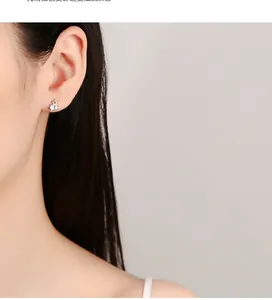 Detailed close-up of 925 sterling silver triple star stud earring on woman ear