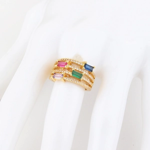 Detail of 18K gold ring with multi-layer band featuring rainbow gemstones and zircon pavé