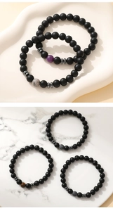 Detail of 8mm matte black stone bracelets with unique center stones and metal spacers