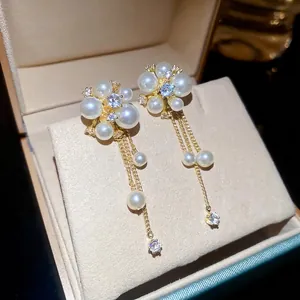 Elegant gold flower pearl tassel drop earrings featuring sparkling zircon crystal details