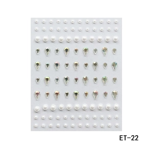 Detail of ET-22 facial gems with white pearls and iridescent teardrop rhinestones