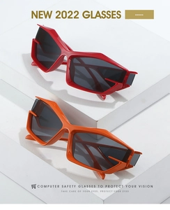 Detail view of modern geometric sunglasses in vibrant orange and bright red frames