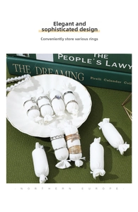 Close-up of white linen ring display pillows on decorative porcelain tray