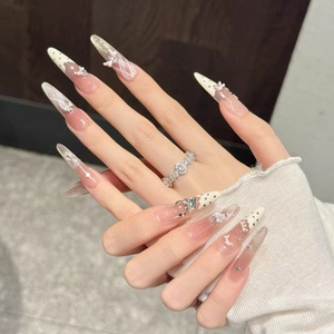 Handmade stiletto press-on nails with 3D bows, pearls, and white polka dot patterns