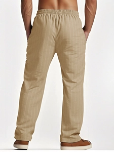 Rear view of men's striped linen pants in beige showing elastic waist and straight cut