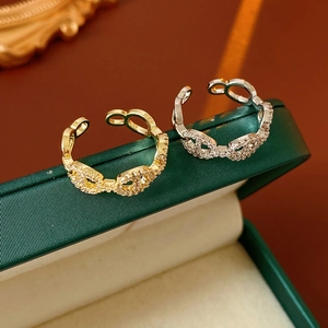 Macro shot of gold and silver plated adjustable rings with pave cubic zirconia details