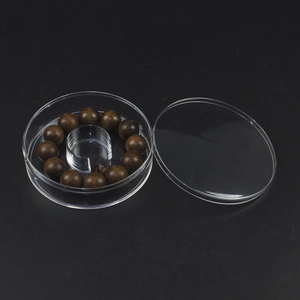 Macro shot of dark wooden beads inside a premium round clear acrylic display box
