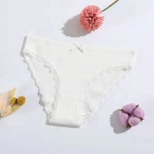 White cotton ribbed women panties with lace trim and bow displayed with flowers