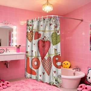 Detail of love heart patterned shower curtain with LOVE text in a pink bathroom setting