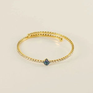 Detail of 18K gold plated bracelet featuring a deep blue square zircon and pavé setting